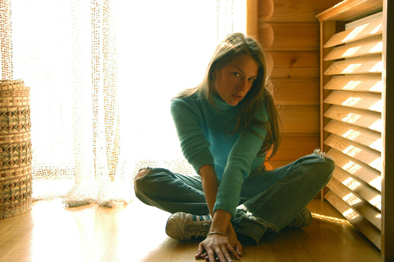 woman sitting on floor in sunlight