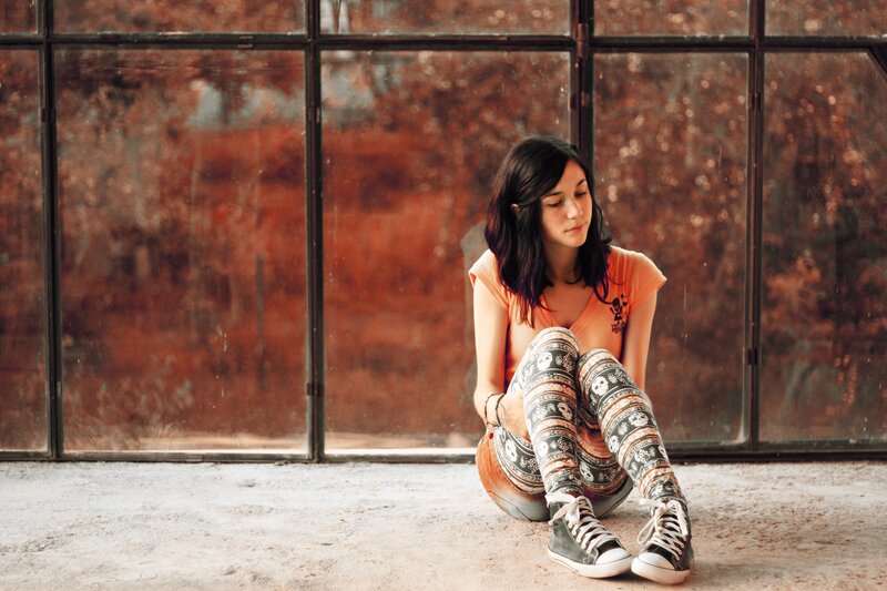 Woman Sitting on Floor — Orange, Contemplative