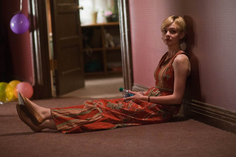 Woman sitting on floor with bottle