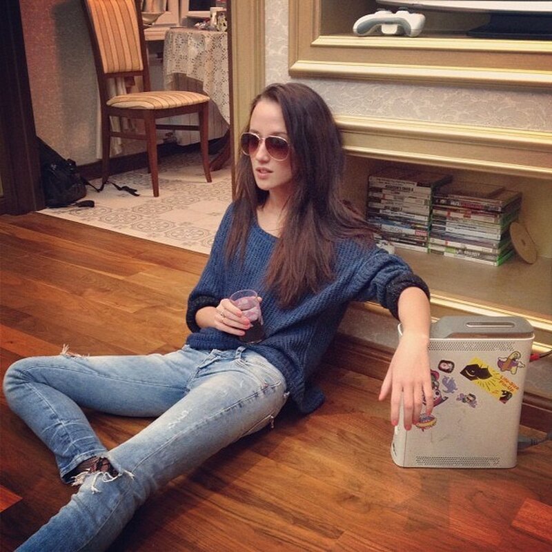 woman sitting on floor with drink