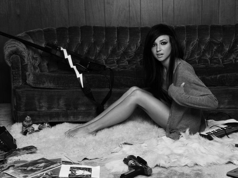 woman sitting on floor with guitar