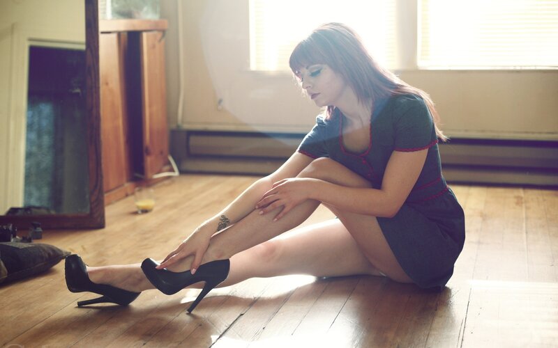woman sitting on floor with heels