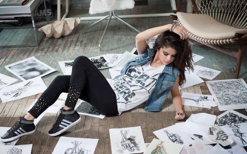 woman sitting on floor with sketches