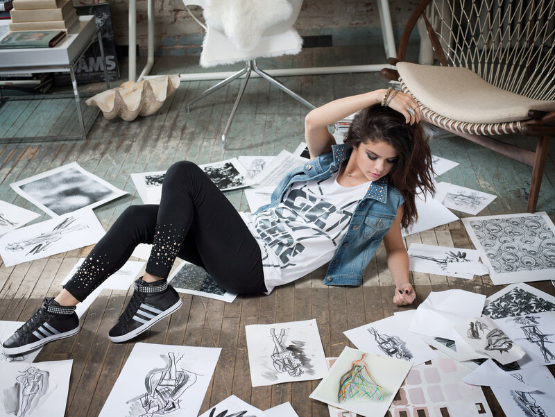 woman sitting on floor with sketches