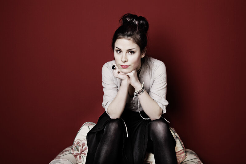 woman sitting on floral couch