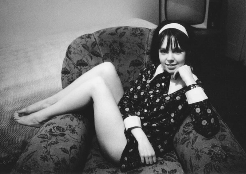 woman sitting on floral couch