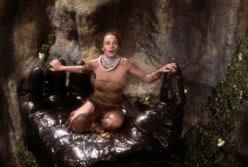 Woman Sitting on Giant Hand