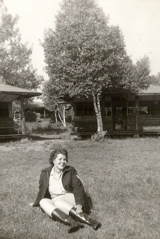 Woman sitting on grass at camp