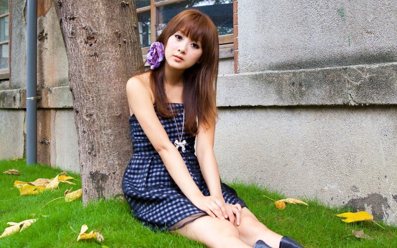 woman sitting on grass by tree