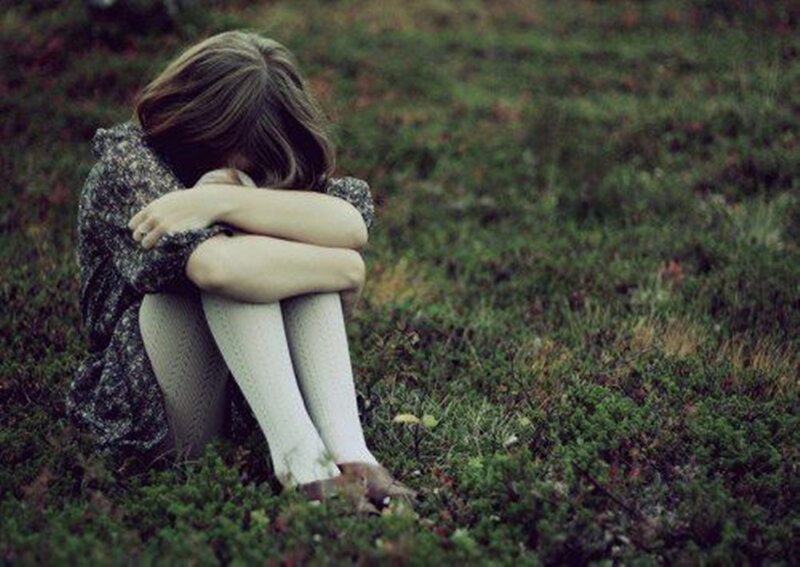 Woman Sitting on Grass — Green, Melancholic