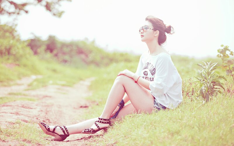 Woman Sitting on Grass — Green, Serene, Afternoon, Photograph, Sunglasses