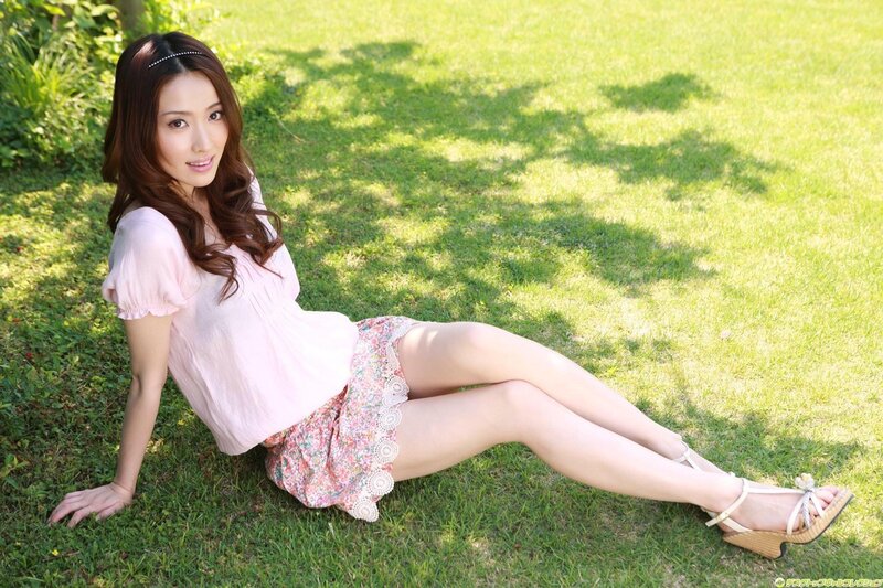 Woman sitting on grass in garden