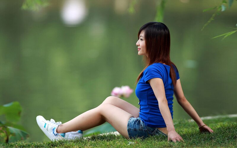 Woman sitting on grass in park