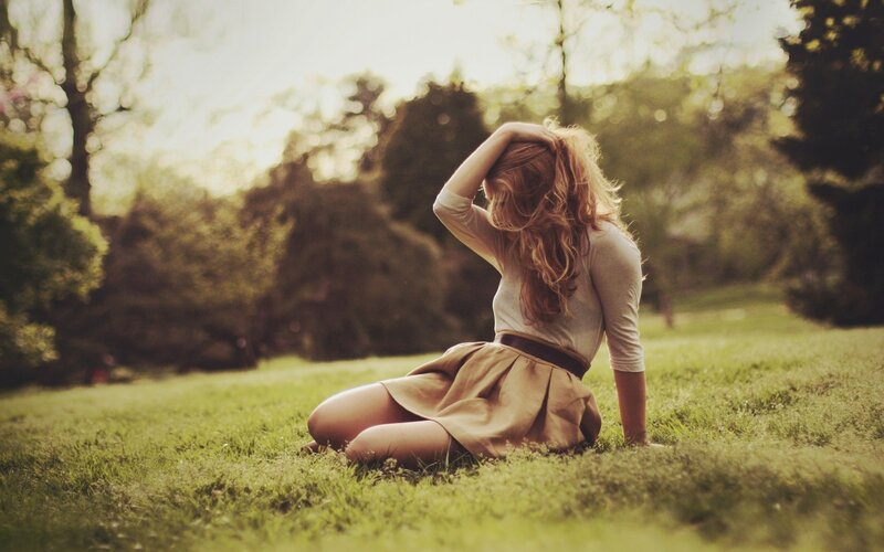 woman sitting on grass in park