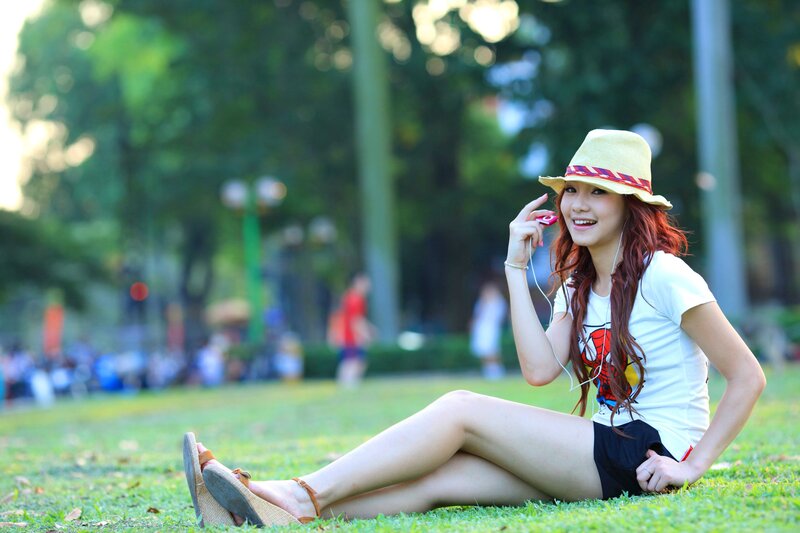 Woman sitting on grass in park