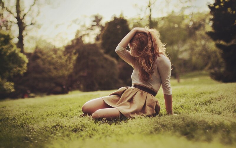 woman sitting on grass in park