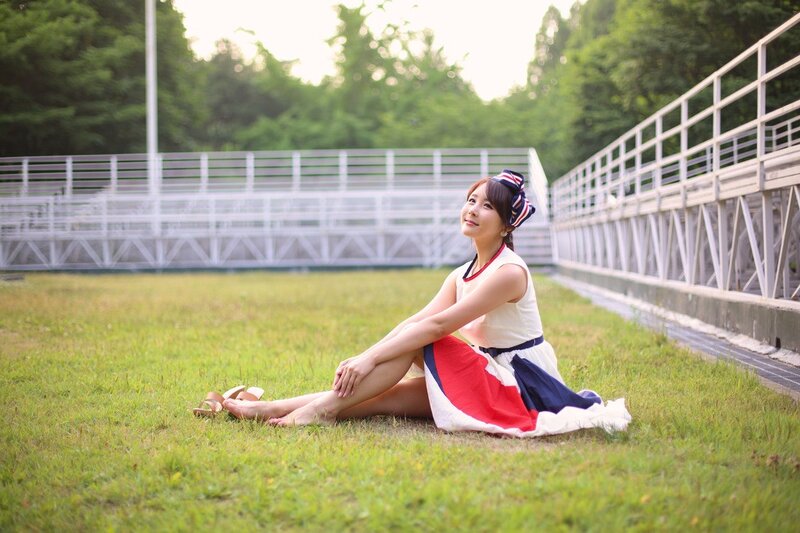Woman sitting on grass in park