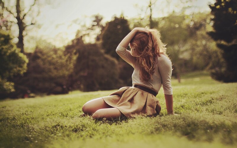 woman sitting on grass in park