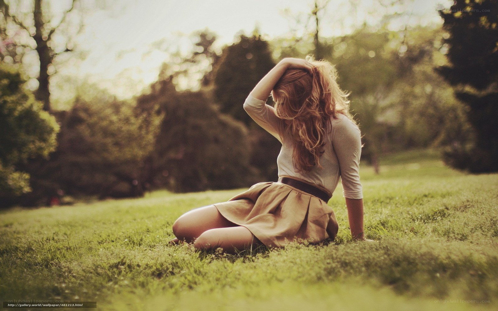 Woman sitting on grass in park