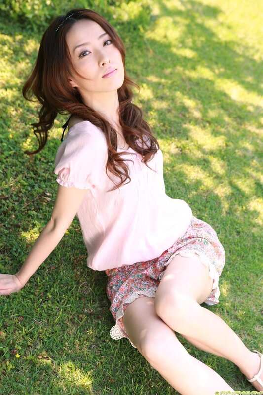 Woman sitting on grass in sunlight