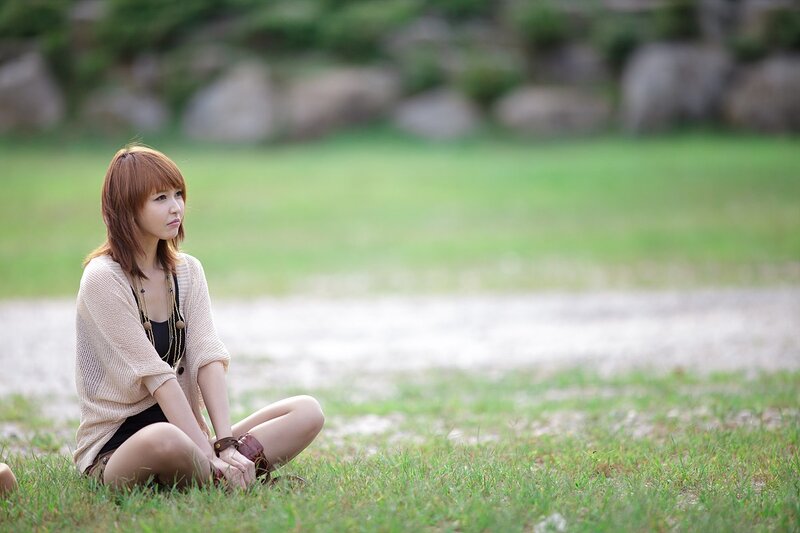 woman sitting on grass outdoors