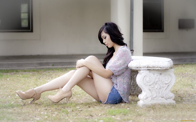 woman sitting on grass outdoors