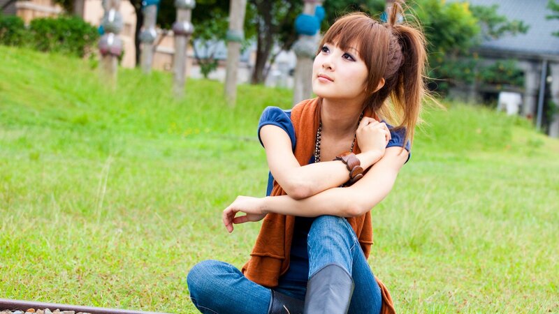 woman sitting on grass outdoors
