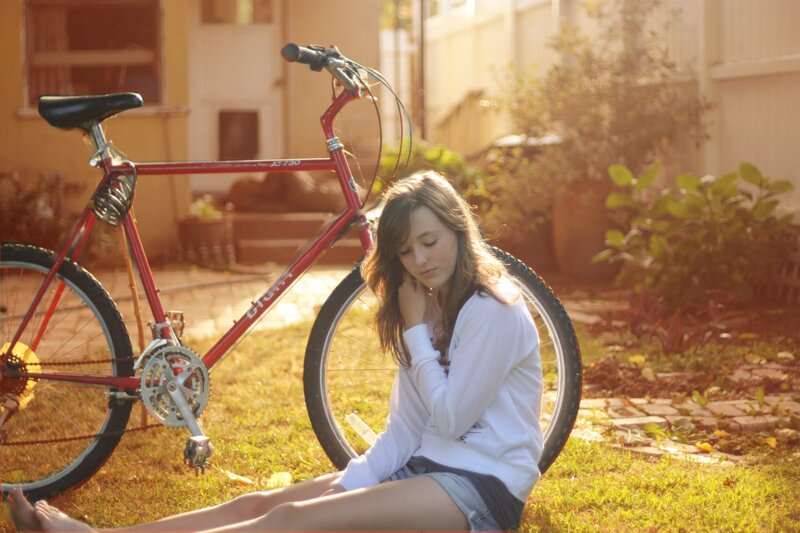 Woman Sitting on Grass — Red