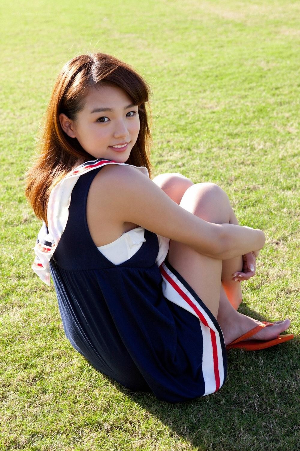 woman sitting on grass smiling