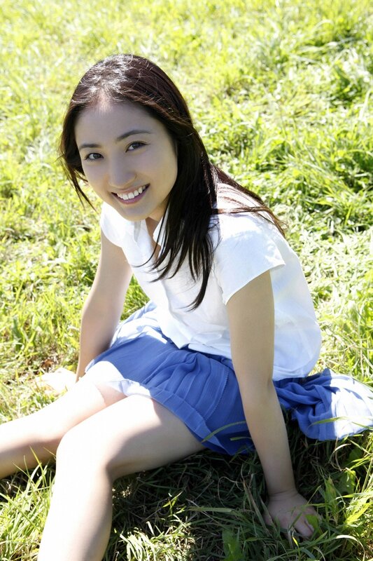 woman sitting on grass smiling