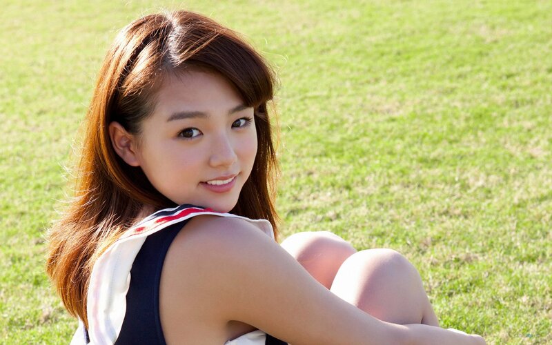 woman sitting on grass smiling