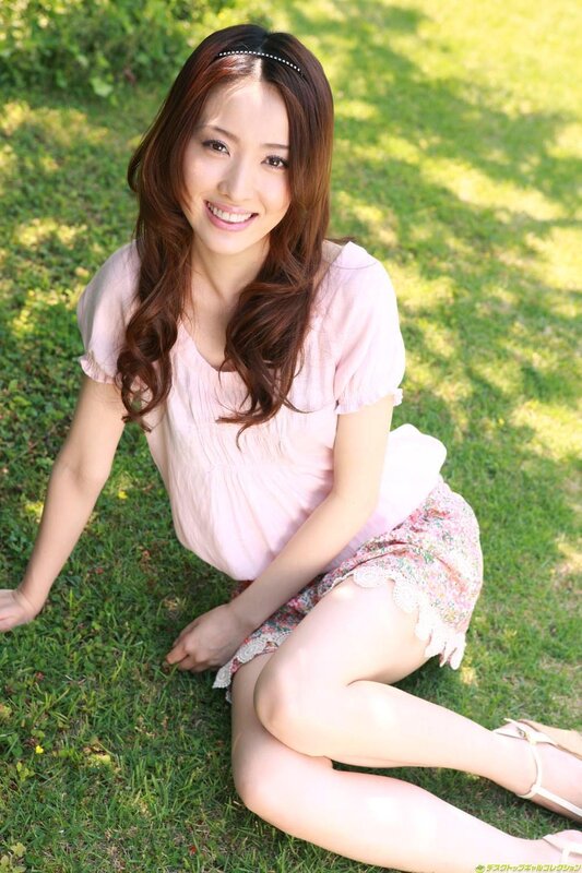 Woman sitting on grass smiling