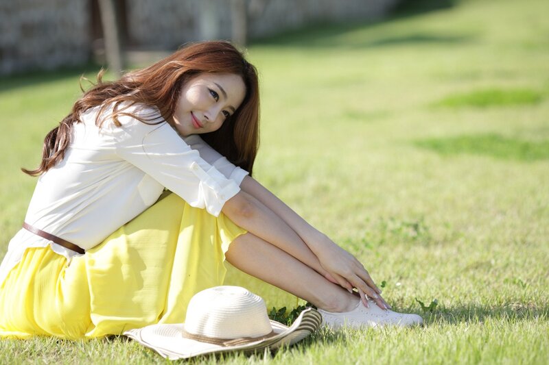 Woman Sitting on Grass — Yellow, Serene, Afternoon, Photograph