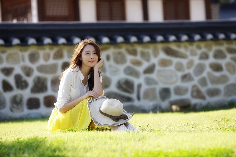 Woman Sitting on Grass — Yellow, Serene