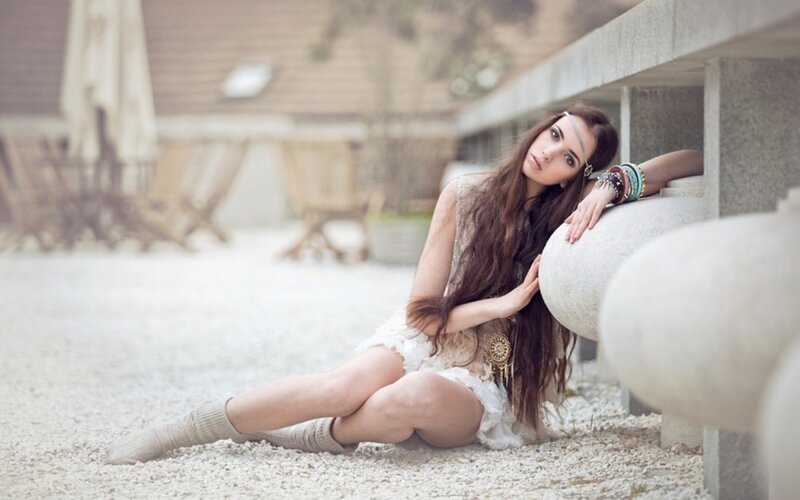 woman sitting on gravel