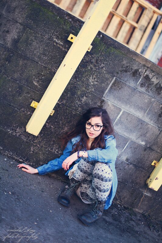 woman sitting on ground in urban setting