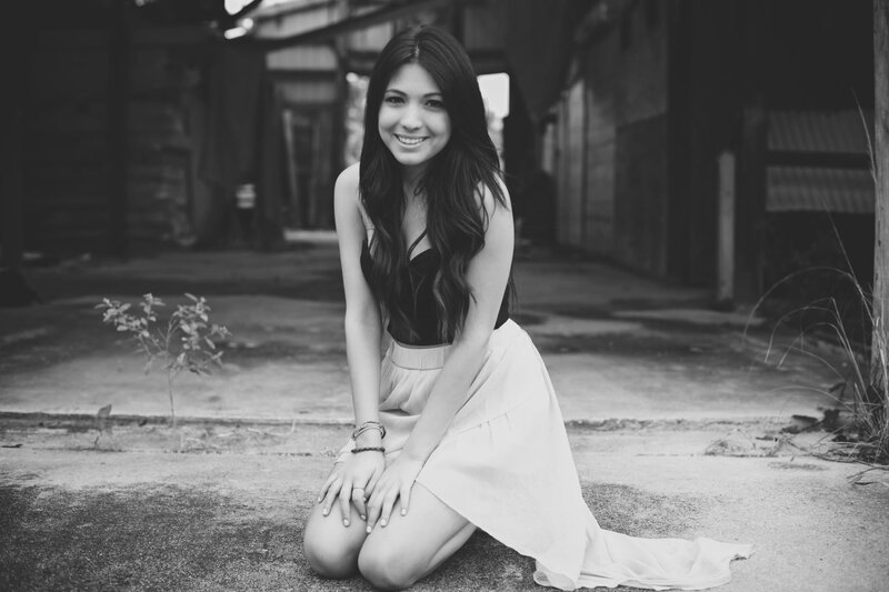 woman sitting on ground smiling