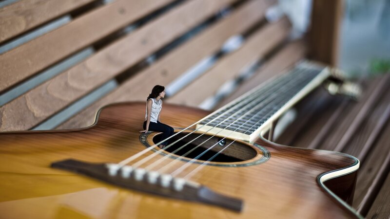 Woman Sitting on Guitar — Brown