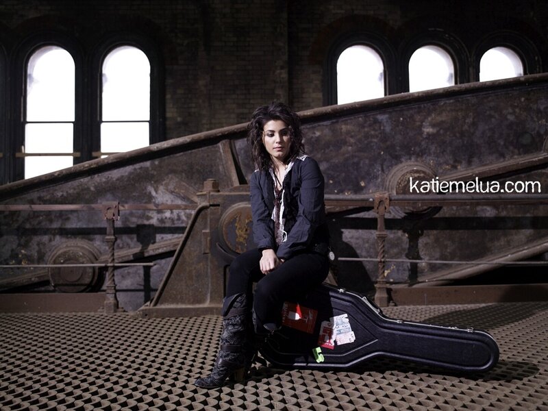 woman sitting on guitar case