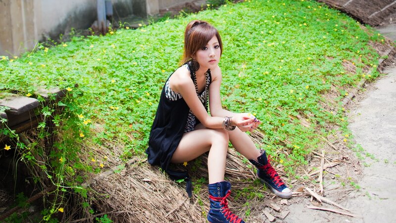 woman sitting on hay in garden