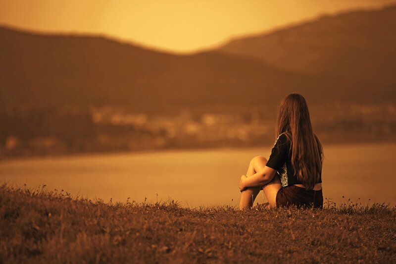 Woman Sitting on Hill