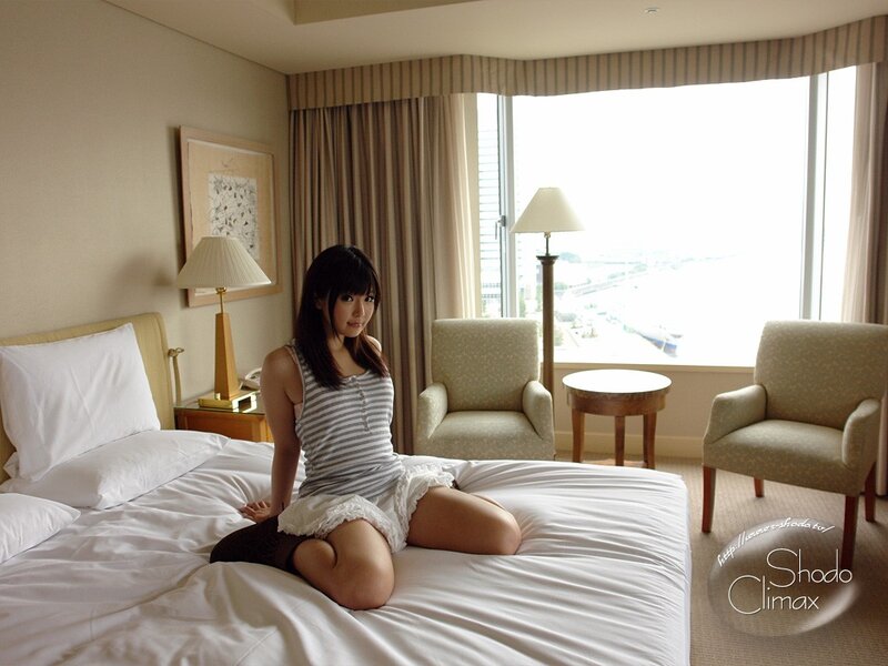 Woman sitting on hotel bed
