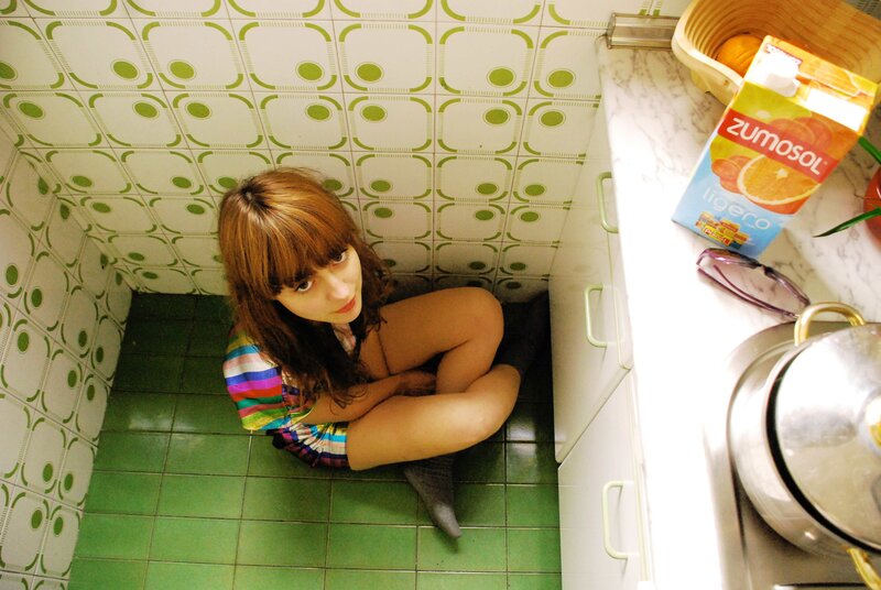 woman sitting on kitchen floor