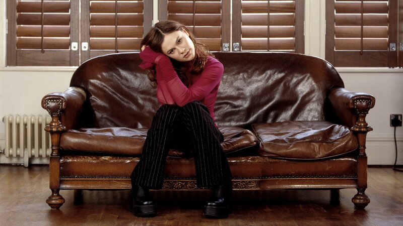 woman sitting on leather couch