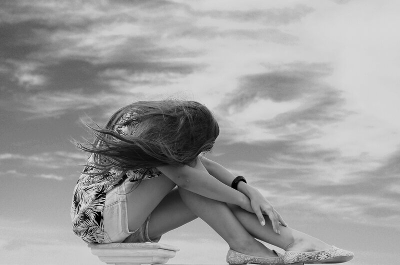 Woman Sitting on Ledge — Black, Dramatic, Photograph