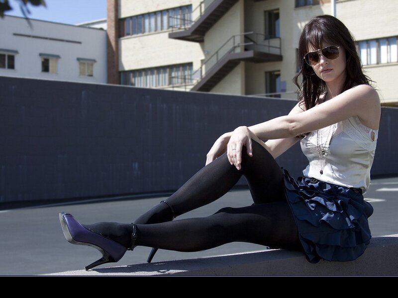 Woman Sitting on Ledge