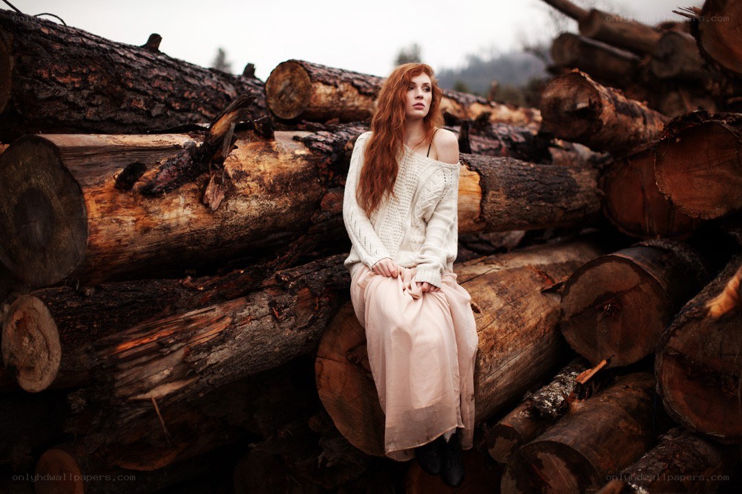 Woman sitting on logs
