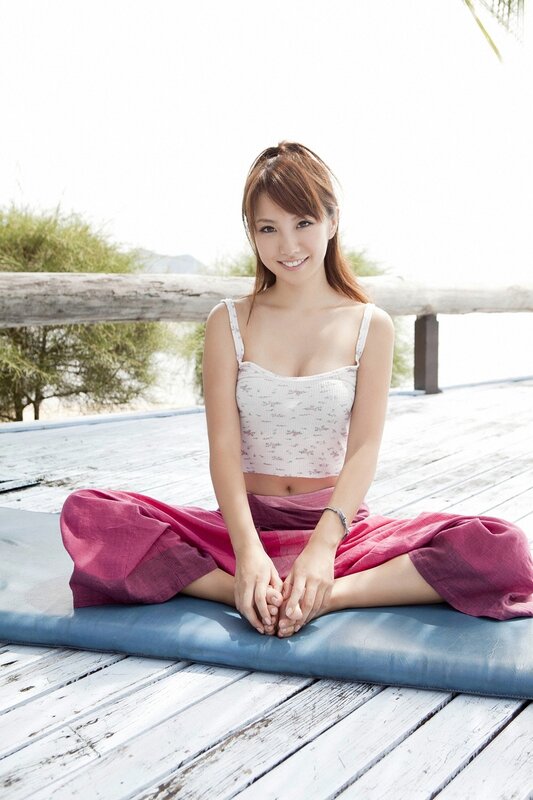 woman sitting on mat outdoors