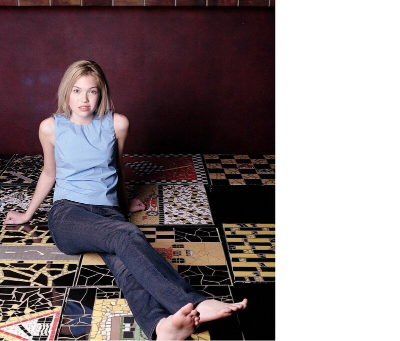 woman sitting on mosaic floor