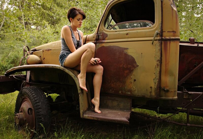 woman sitting on old truck